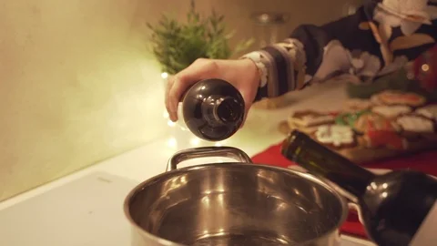Red wine is poured into the pan for making mulled wine. Stock Footage 100976906