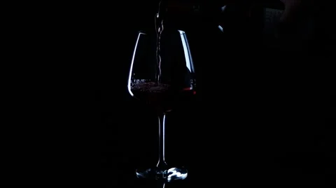 Red wine pouring black background / Rotwein Stock Footage 52129167