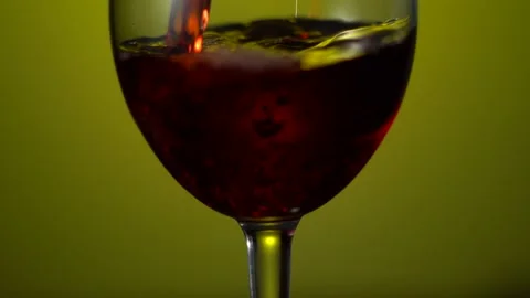 Red wine pouring from bottle to clear glass. Red Wine cellar with bottle and Stock Footage 153531622