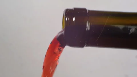 Red wine is pouring from the bottle. Close-up. Stock Footage 104090491
