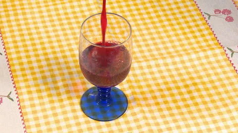 Red wine pouring in cup on table Stock Footage 22685574