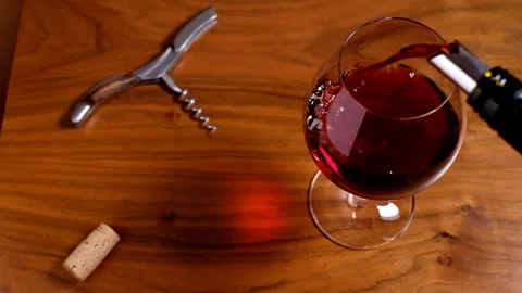 Red wine pouring in a wine glass from above Stock Footage 139968853