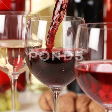 Red wine pouring into a wine glass Stock Photos