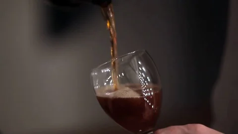 Red wine. Red wine is poured in a glass. I pour beautiful wine under an Stock Footage 70318816