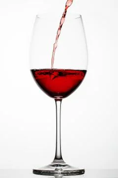 Red wine splashes in a glass Stock Photos