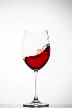 Red wine splashes in a glass Stock Photos