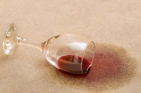 Red wine stain on a carpet inside a living room Stock Photos