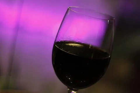 Red wine, violet background Stock Photos