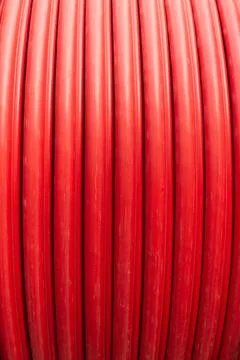 Red wire cable in reels close up on coil Stock Photos