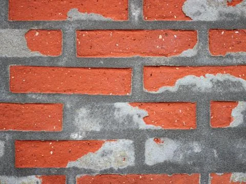 Red Worn Repaired Brickwall Background with Uneven Mortar Stock Photos