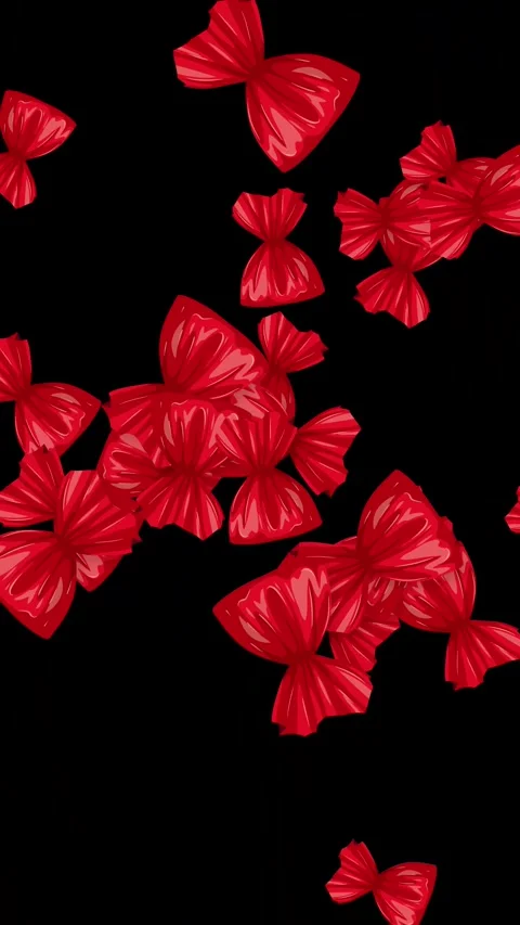 Red Wrapped Candy Pieces Bursting on Black Background Vertical Animation Stock Footage 345120753