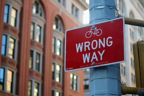 Red Wrong Way for bicycle direction traffic sign in Manhattan in New York Cit Stock Photos