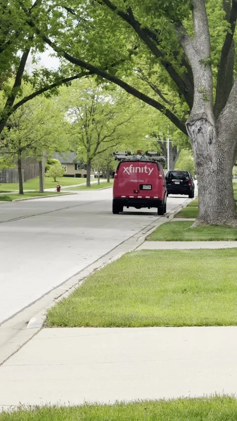 Red Xfinity Van Parked Near Curb on Summer Day Stock Footage 340562856