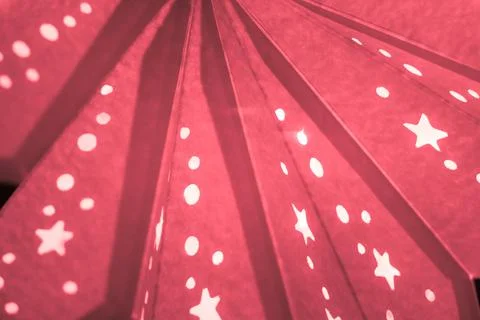 Red xmas lantern star pattern at christmas market season. Shiny star mood lam Stock Photos