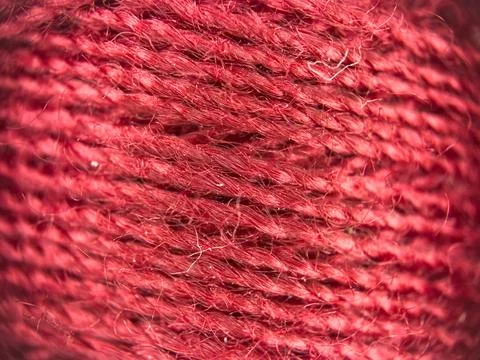 Red yarn thread texture close up macro concept for knitting, textile industry, 库存照片