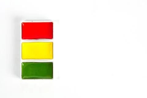Red Yellow and Green solid watercolor pans on white background with copy spac 스톡 사진