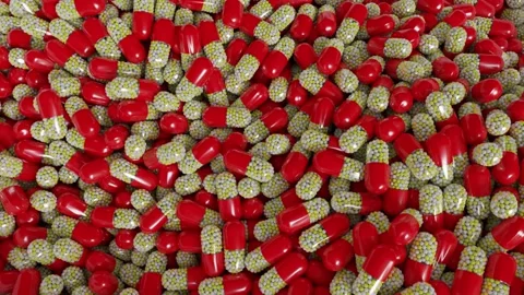 Red, yellow and white pills or capsules tumbling Stock Footage