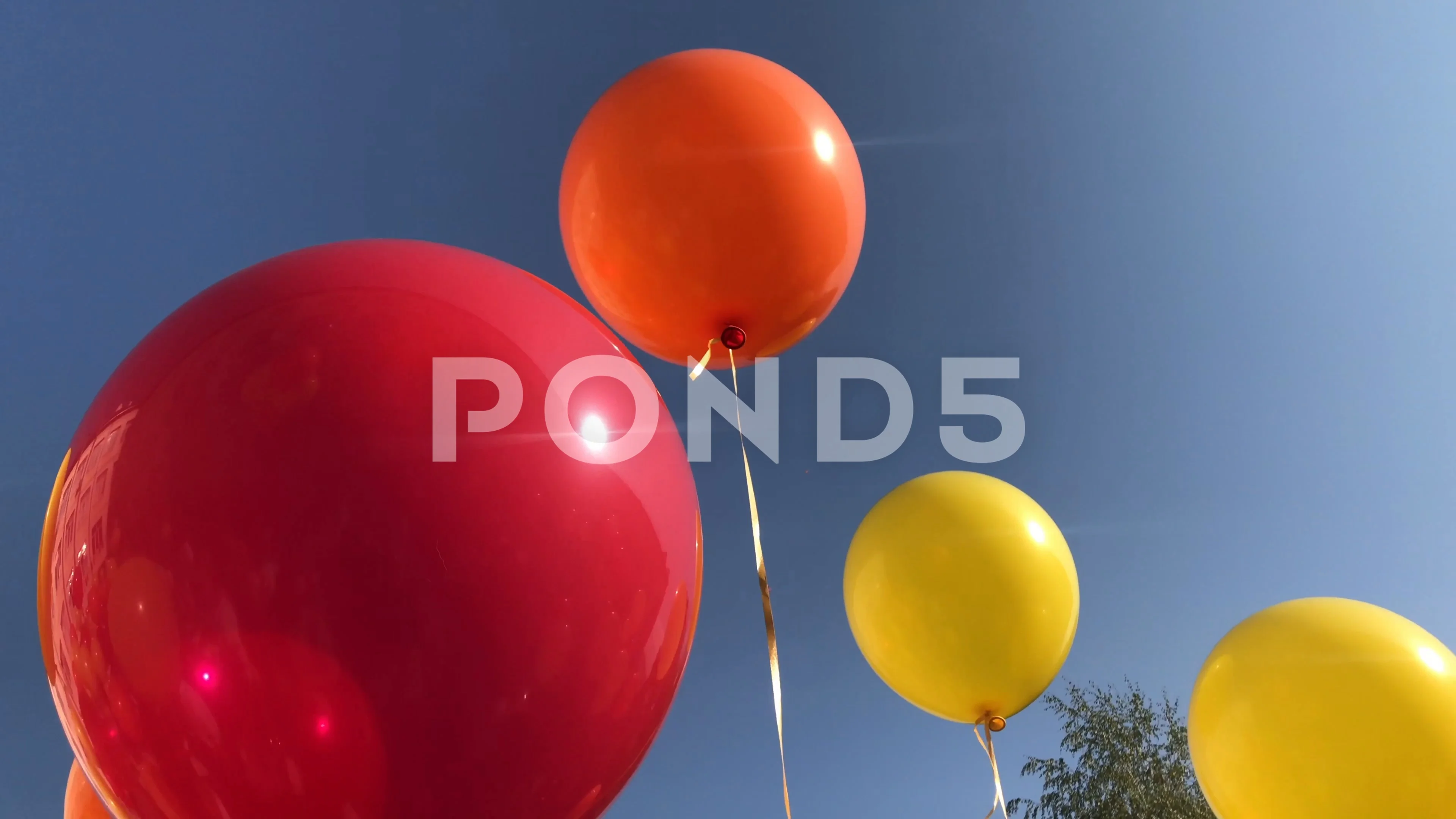 A red yellow balloon tied to a string fl, Stock Video