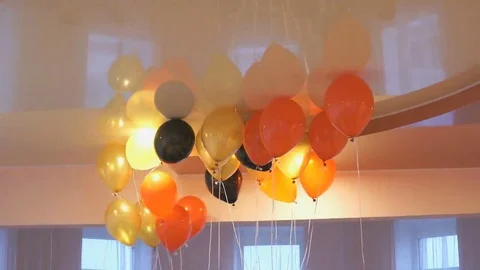Red, yellow balloons floating on the ceiling Stock Footage 69257650