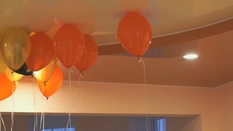 Red, yellow balloons floating on the ceiling Stock Footage 69836974