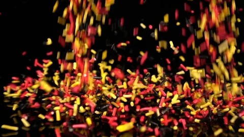 Red, Yellow, Black Sprinkles falling in slow motion. 库存影片 88615630