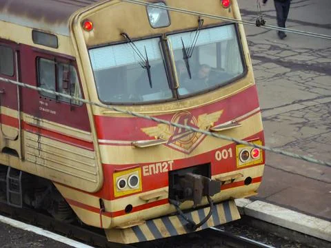 Red, yellow, white train engine Number 01 with a shield-wing symbol, moving.. Foto stock
