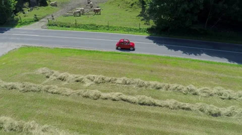 Red yugo passing a tractor Video stock 54296141