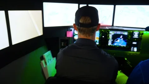 Redbird flight simulations logo and pilot with a teacher with navigation map Stockbeeldmateriaal 115894967