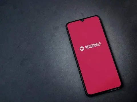 Redbubble app launch screen on smartphone on dark marble stone background Foto stock