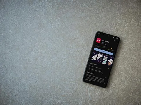 Redbubble app play store page on smartphone on ceramic stone background Stock Photos