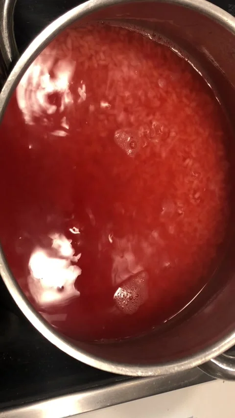 RedColoredRiceLiquidCookingCloseUpFoodTextureBackground Stock-Footage 331944650