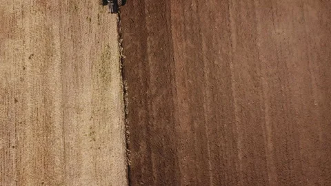 A redder tractor plows a field Stock Footage 127742145