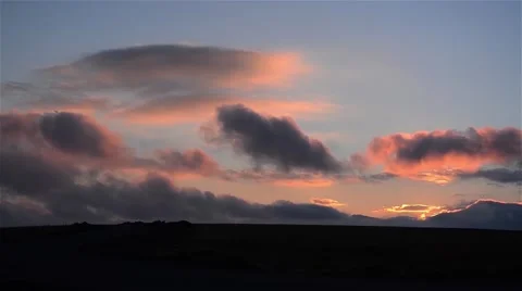 Reddish and gray clouds fleeing driven by wind over some hills Stock Footage 58815963