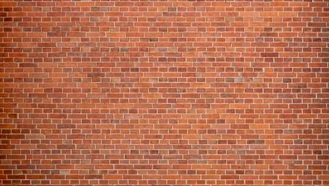 Reddish Brick Wall of an Old Building. Background of a Wall With Old Stones. Stockfoto's