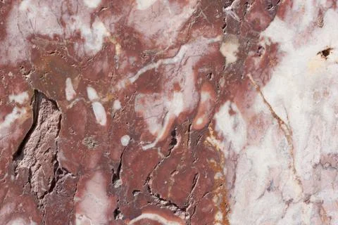 Reddish-brown base with dark and gray spots. Classic travertine texture. Stock Photos