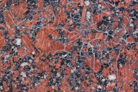 Reddish-brown granite texture with black and gray spots.Used as a background. Stock Photos