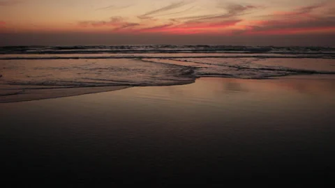 Reddish ocean sunset, small crossing waves during low tide. Nature background. Stock Footage 285161753