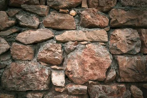 Reddish stone wall background texture Stock Photos