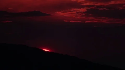 Reddish sunset over mountains with dense forests Stock Footage 78218927