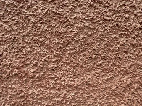 Reddish wall with granular texture Stock Photos