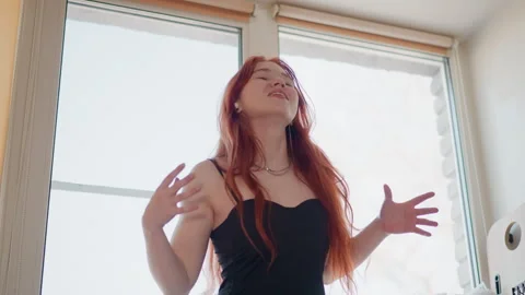 Redhaired actress passionately enacts dramatic story by window. Redheaded Stock Footage 347526128