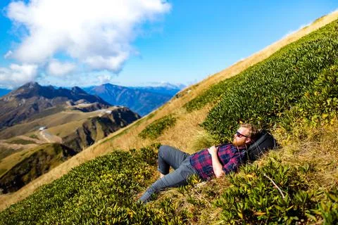Redhaired ginger beard man resting in hills landscape in summer day Stock Photos