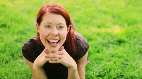Redhaired girl having fun on grass Stock Footage 7740926