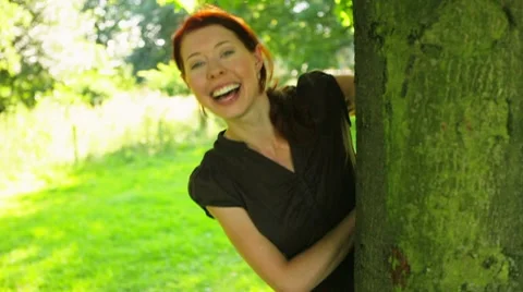 Redhaired girl playing in park Stock Footage 7740978