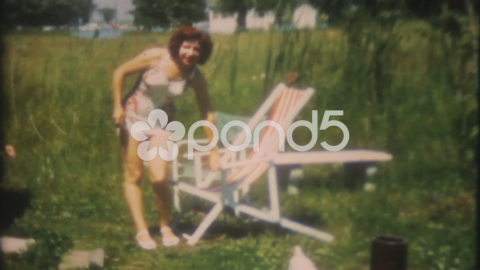 redhead in bathing suit gets sun in backyard 1950s vintage film home movie  1603