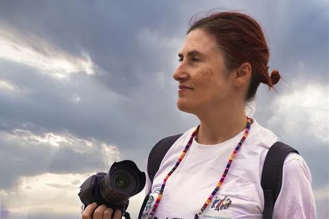 Redhead with camera and backpack Foto stock