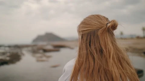 Redhead female hairs contemplating dramatic sea beach landscape pensive dreaming Stock Footage 225875220