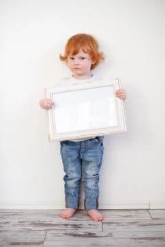 Redhead funny boy with a frame Stock Photos