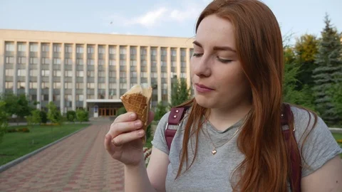 Redhead girl eats delicious ice cream Stock Footage 113125367