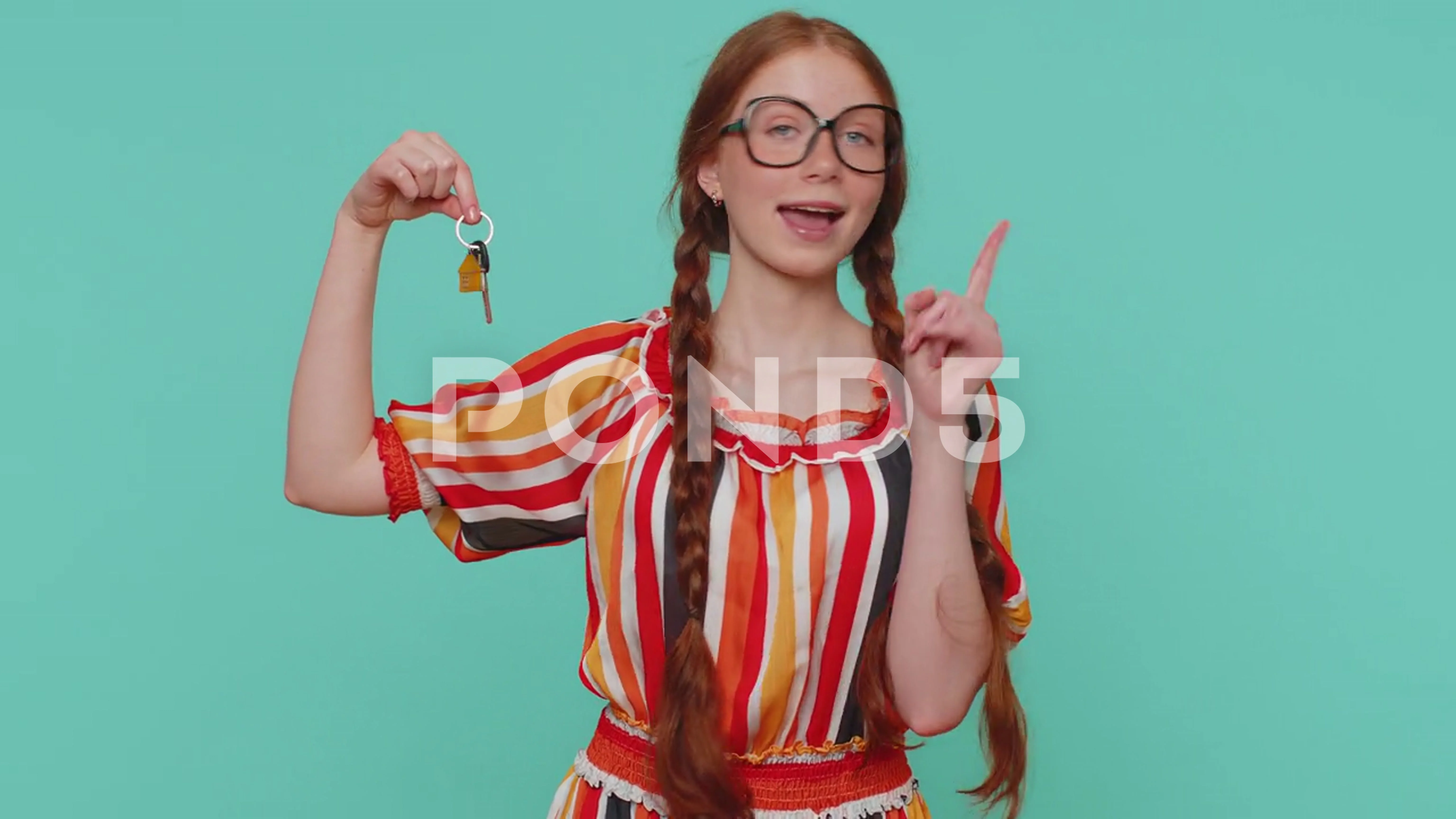 Redhead girl real estate agent show keys of new home house apartment buying